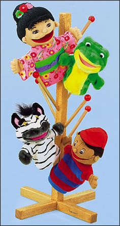 three stuffed animals hanging from a wooden pole