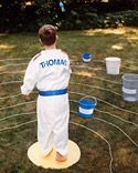 a young boy standing on top of a frisbee golf course