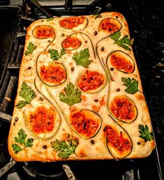 a square pizza sitting on top of a stove