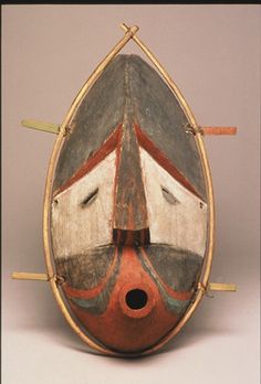 an old wooden mask is on display