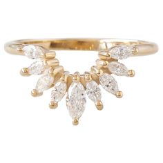 a gold ring with three pear shaped diamonds