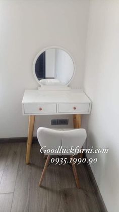 a white desk with a mirror on top of it and a chair in front of it