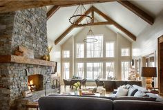 a living room filled with lots of furniture and a fire place in the middle of it