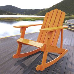 This traditional Adirondack rocker adds vintage charm to your porch, deck or patio; Comfortable slat-back rocking chair has an arched top for classic resort style; Handcrafted from durable acacia wood, with sturdy construction that's built to last JONATHAN Y Kiawah Light Brown Wood Frame Stationary Adirondack Chair with Solid Seat | PAT1000A Adirondack Rocking Chair, Modern Outdoor Spaces, Porch Deck, Outdoor Rocking Chairs, Heavy Rain, Adirondack Chairs, Cedar Wood, Porch Patio, Resort Style