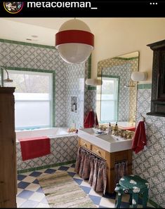 a bathroom with a checkered floor and wallpaper on the walls, along with a large bathtub