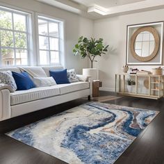 a living room filled with furniture and a large rug on top of a hard wood floor