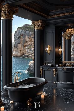 an ornate bathroom with black marble and gold fixtures, along with a view of the ocean