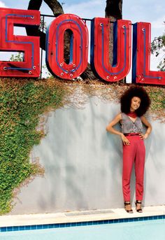 a woman standing in front of a pool with the word soul on it's side