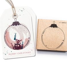 a wooden stamp with a christmas ornament on the front and a merry christmas ornament on the back