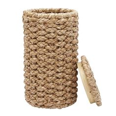 a large woven basket next to a wooden stick on a white background with clippings