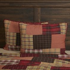 a bed topped with two pillows next to a wooden headboard