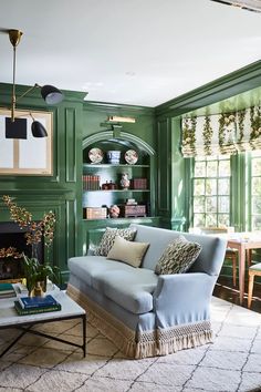 a living room with green walls and furniture