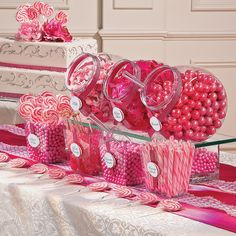 a table topped with lots of candy and lollipops on top of it