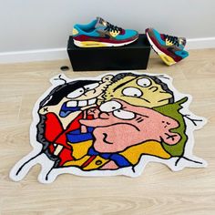 the rug is on the floor next to shoes and a pair of sneakers with cartoon characters