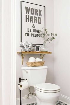 a white toilet sitting in a bathroom next to a shelf with a plant on it