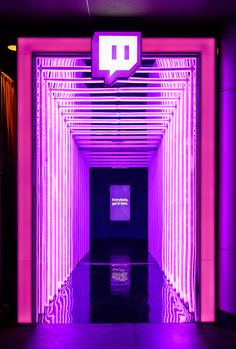 the entrance to a building with purple lighting