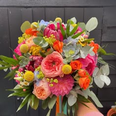 a person holding a bouquet of flowers in their hand