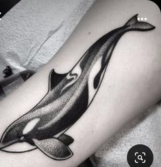 an orca whale tattoo on the leg