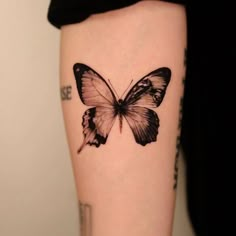 a small black and white butterfly tattoo on the right thigh, it appears to be in color