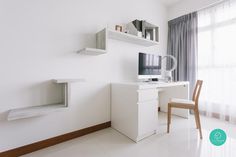 a white room with a desk, chair and shelves on the wall next to a window