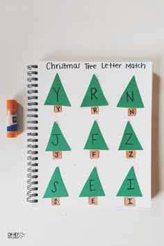 a christmas tree letter match is shown on a notebook