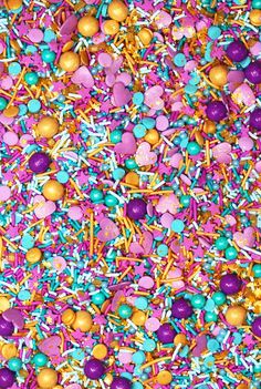 colorful sprinkles and candies are scattered on the ground in this image