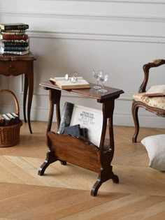 two wooden tables with books and wine glasses on them