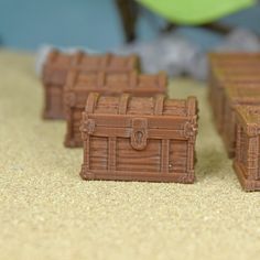 three small wooden chests sitting on top of a table