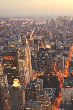 an aerial view of new york city at night from the top of the empire building