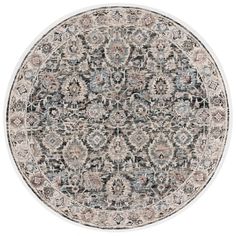 a round rug with an ornate design in grey and blue colors on the inside of it