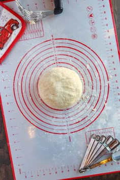 a doughnut sitting on top of a table next to measuring tape and utensils