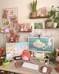 a desk with two computer monitors, keyboard and various other items on top of it