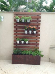 an outdoor planter with potted plants on it