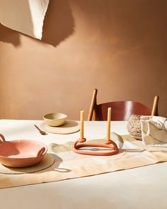 the table is set with plates, bowls and utensils