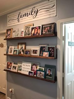 the wall is filled with family pictures and books on it's shelves, along with other personalized items