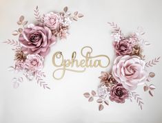 the word ophela is surrounded by pink flowers and leaves on a white background