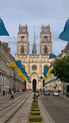 an image of a city street with flags flying in the air