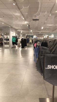 the inside of a clothing store with clothes on display