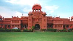 the building is made of red bricks and has many arches on it's sides