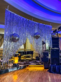 a dance floor with chandeliers hanging from the ceiling