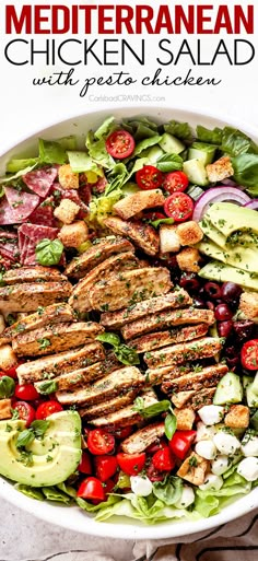 chicken salad with tomatoes, cucumber and lettuce in a white bowl