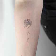 a woman's arm with a flower tattoo on it that reads, i love you