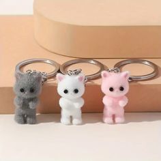 three key chains with small animals on them