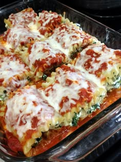 lasagna casserole with cheese and spinach in a glass baking dish