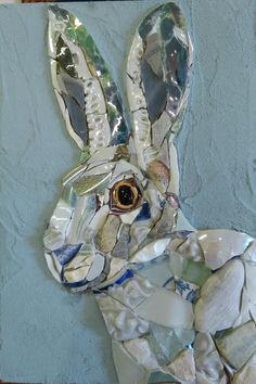 a rabbit made out of broken glass and shells