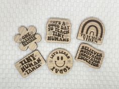 four wooden magnets that say it's a good day to teach tiny humans