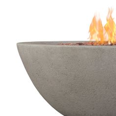 a concrete fire pit with flames coming out of it's sides and on top