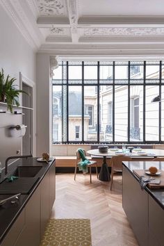 the kitchen is clean and ready to be used for dinner or lunchtime, with plenty of natural light coming in from the large windows