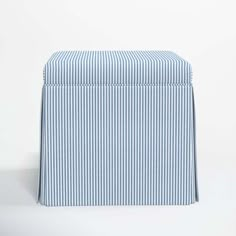 a blue and white striped box sitting on top of a table