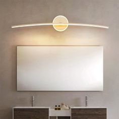 a bathroom vanity with two sinks and a large mirror on the wall next to it